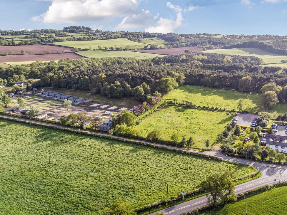 An aerial view of fields and cabins at Cedar Lodge 2 Bedrooms with hot tub in Delamere