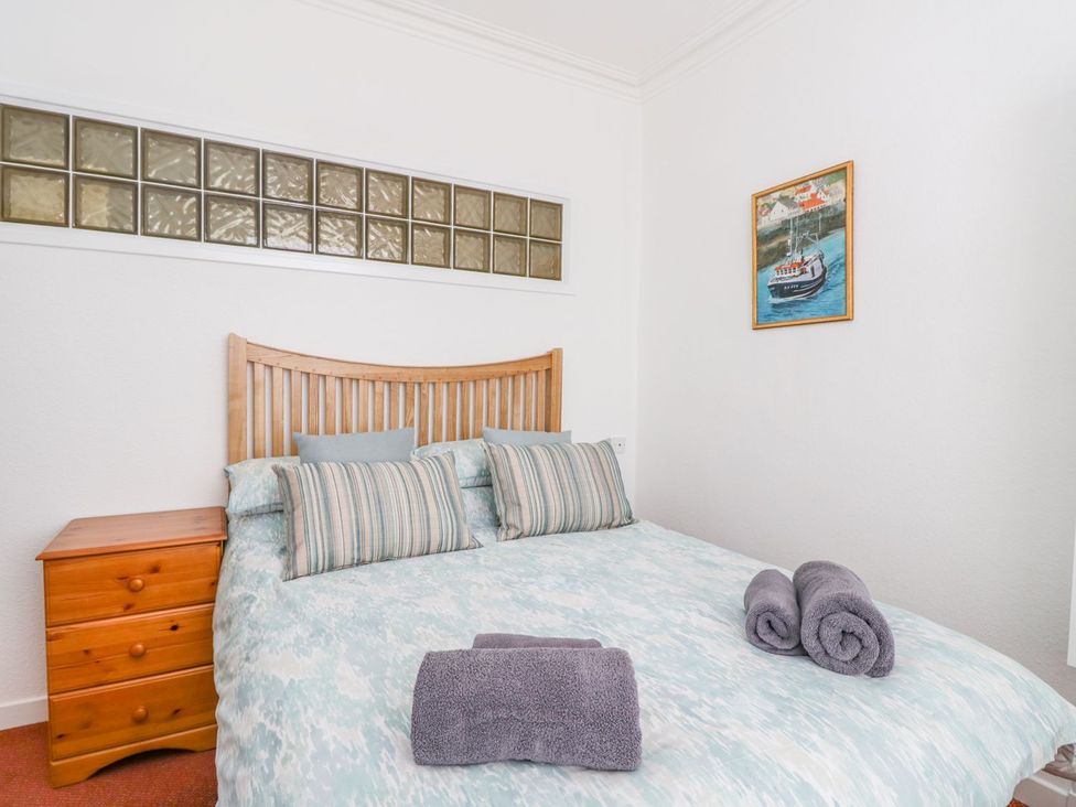 A bedroom with a bed and a bedside table at Maimie’s Harbourview Anstruther