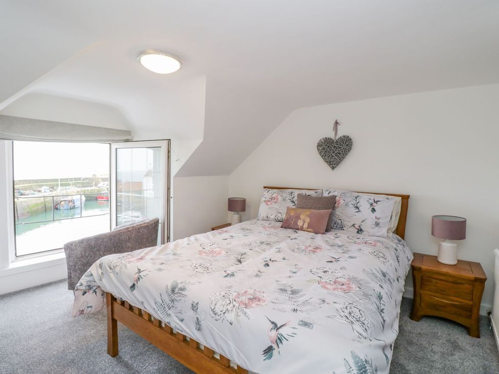 A bedroom with a bed and a window view at Maimie’s Harbourview Anstruther