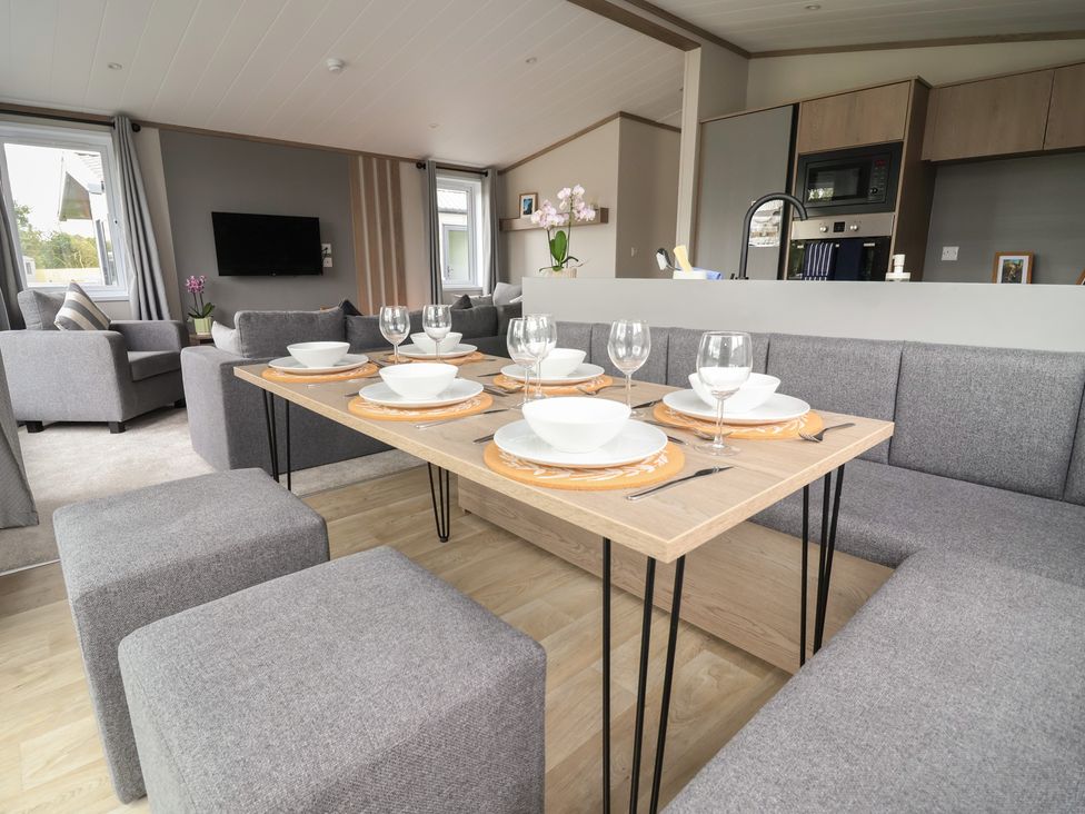 A dining area with a table set for dinner at Cedar Lodge 2 Bedrooms Delamere