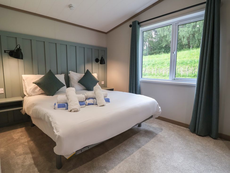 A bedroom with a bed and window at Cedar Lodge 2 Bedrooms Delamere