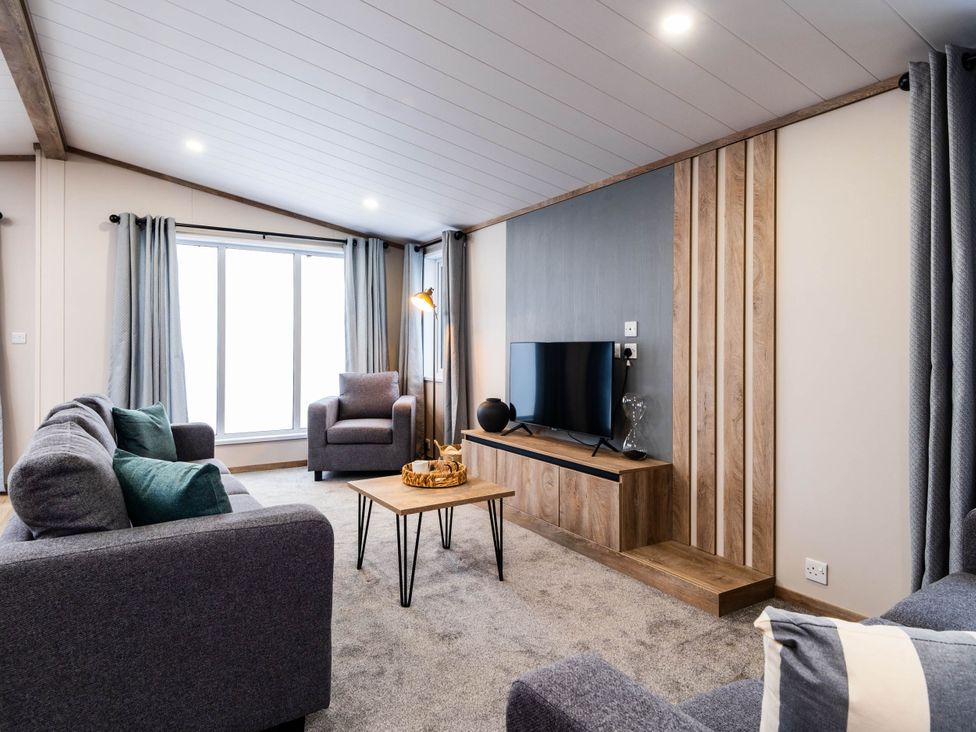 A living room with sofa and television at No 12 Whitefield Lodge Retreat Northwich