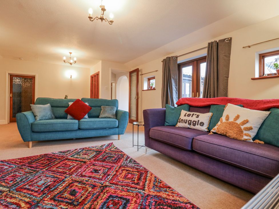 A living room with sofas and a rug at The Pantiles in Banham