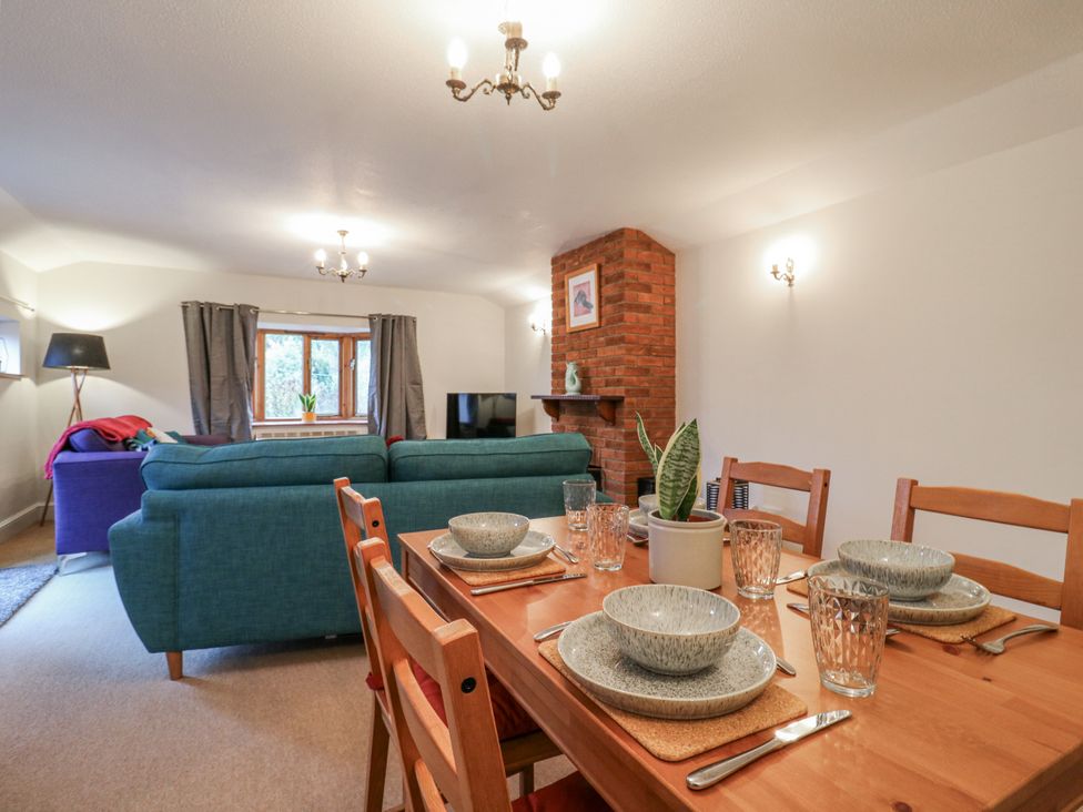 A dining area with a table and chairs at The Pantiles in Banham