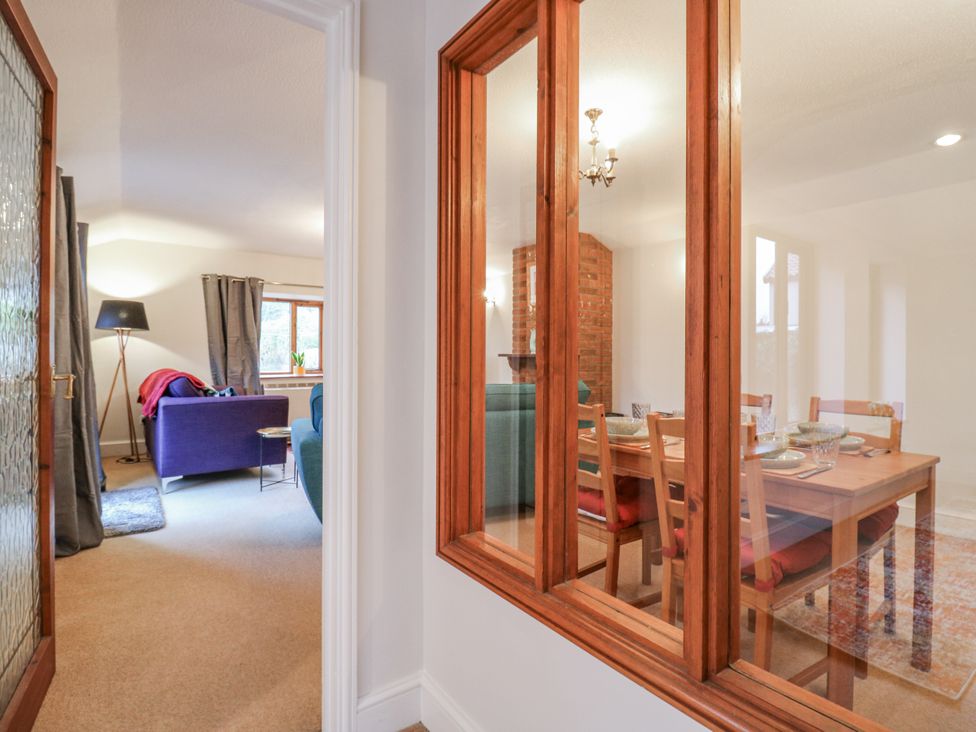 A living room with a dining area and a sofa at The Pantiles in Banham