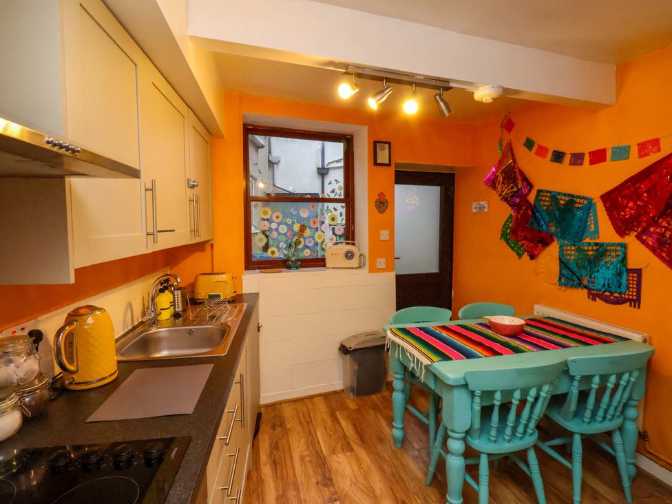 A kitchen with a table and chairs at Frida's Cottage in Whitby