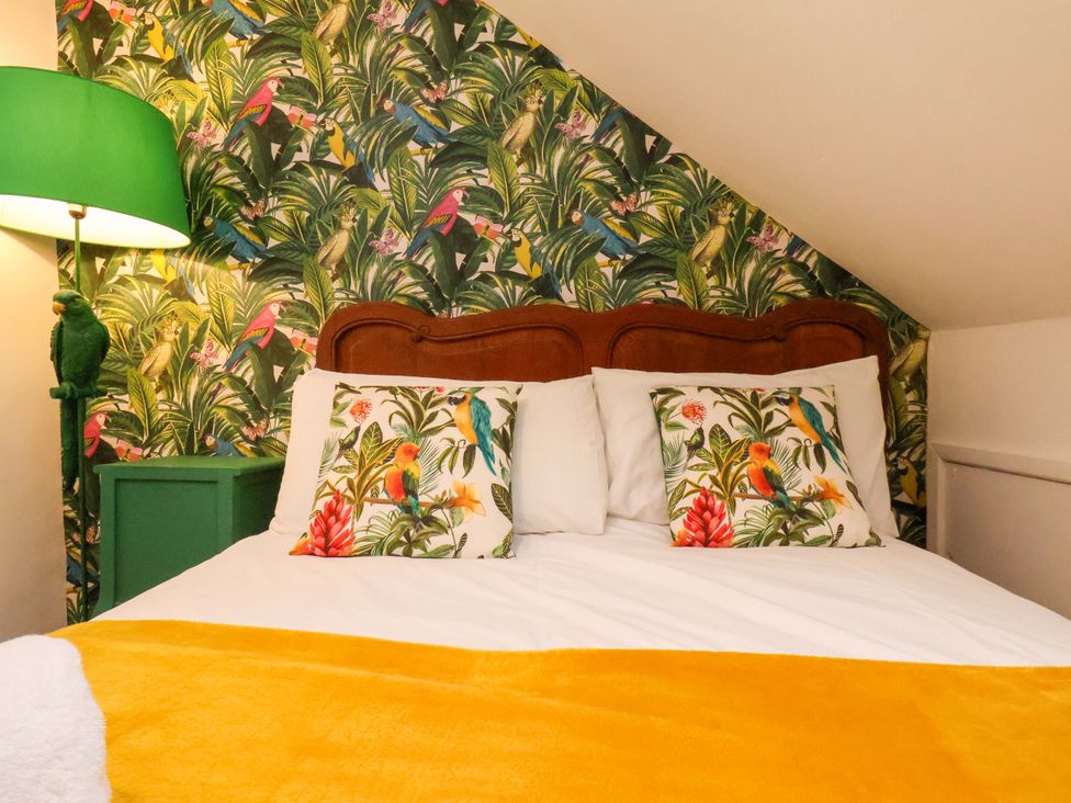 A bedroom with a bed and lamp at Frida's Cottage in Whitby