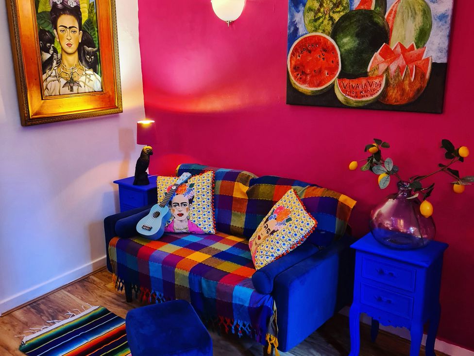 A living room with a sofa and artwork at Frida's Cottage in Whitby