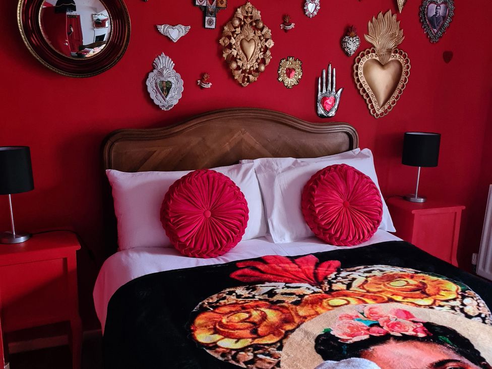 A bedroom with a bed and wall decor at Frida's Cottage in Whitby