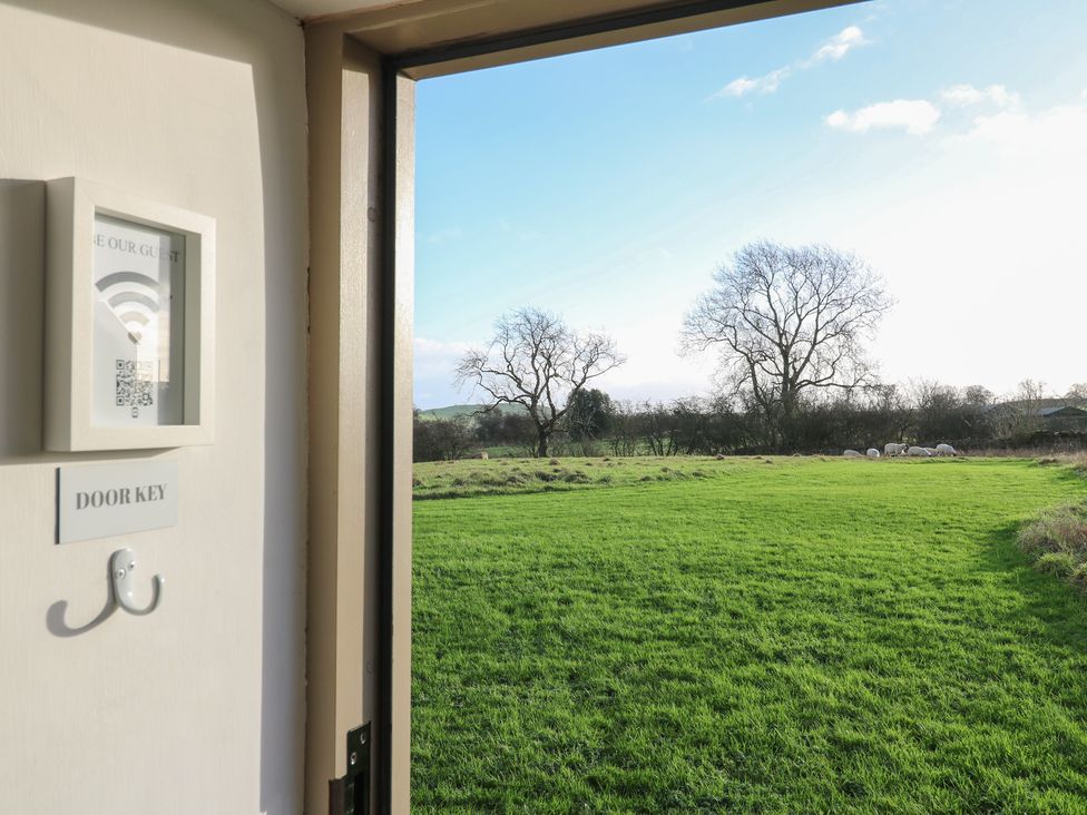 A view from an open door with a key hook and QR code at Little Barn in Leek