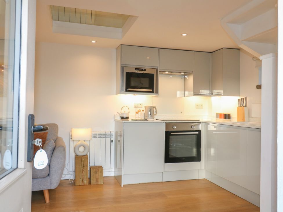 A kitchen featuring appliances and a sitting area at Little Barn in Leek