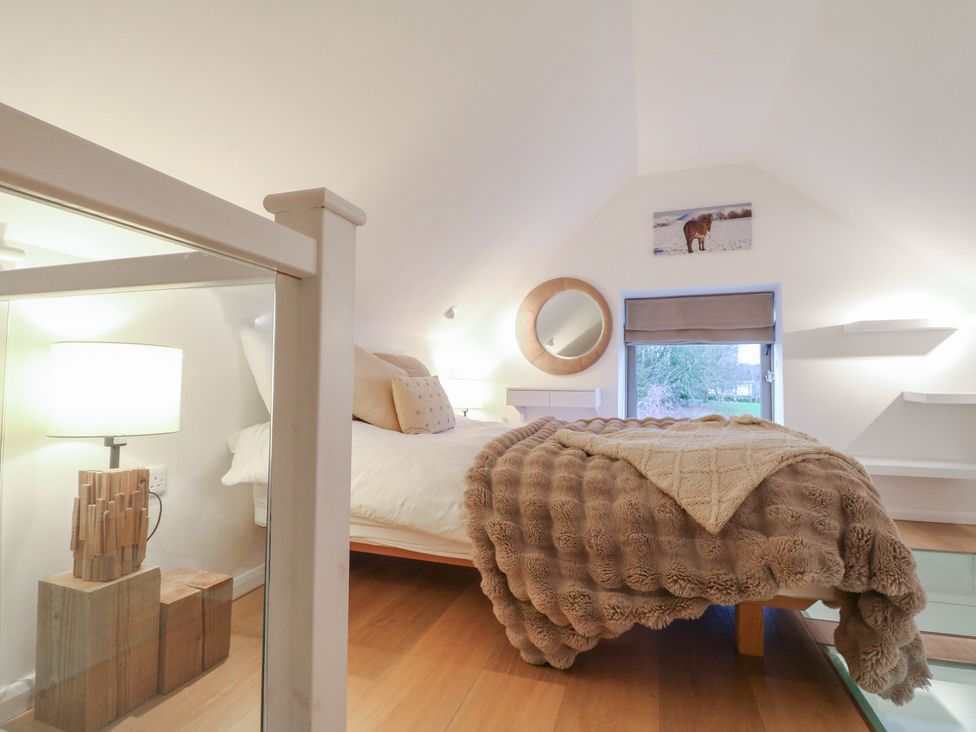 A bedroom with a bed and lamp at Little Barn in Leek