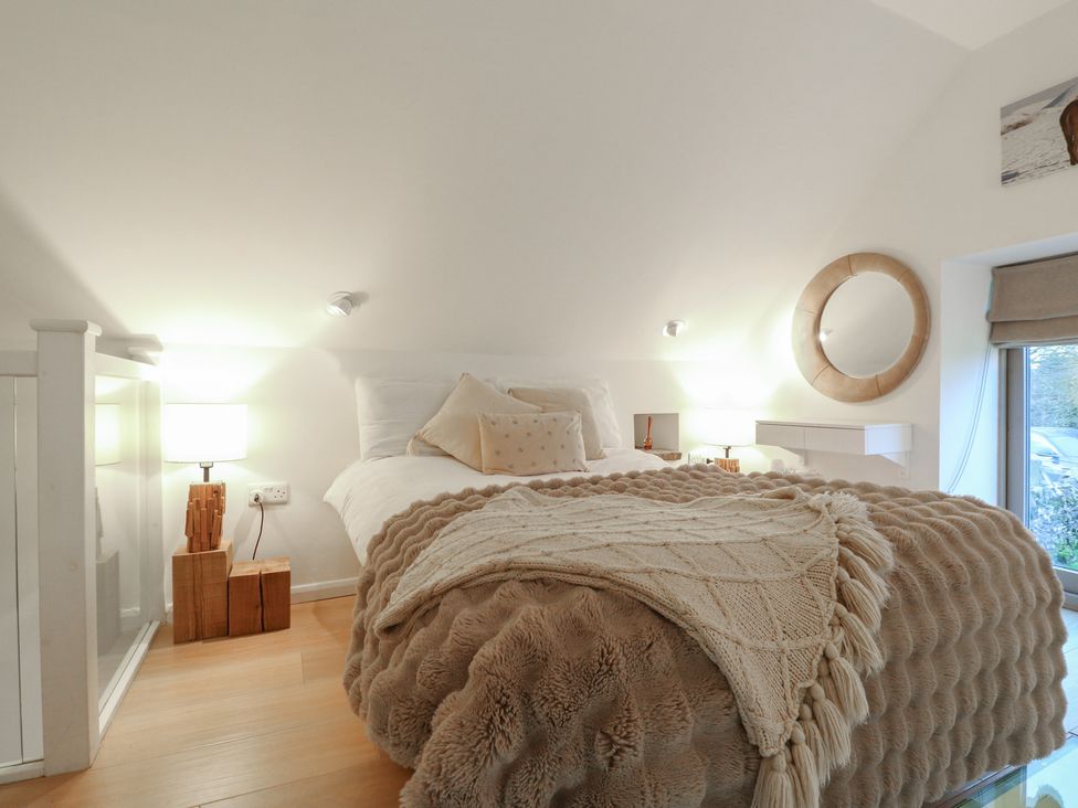 A bedroom with a bed and bedside table at Little Barn in Leek