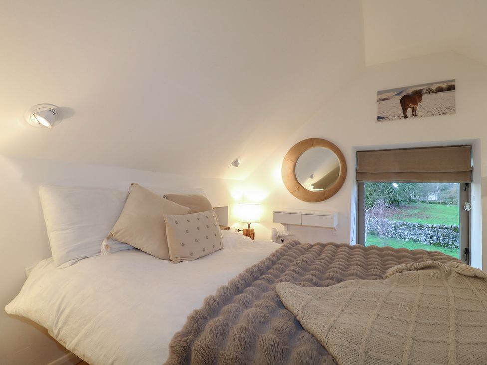 A bedroom with a bed and a window at Little Barn in Leek