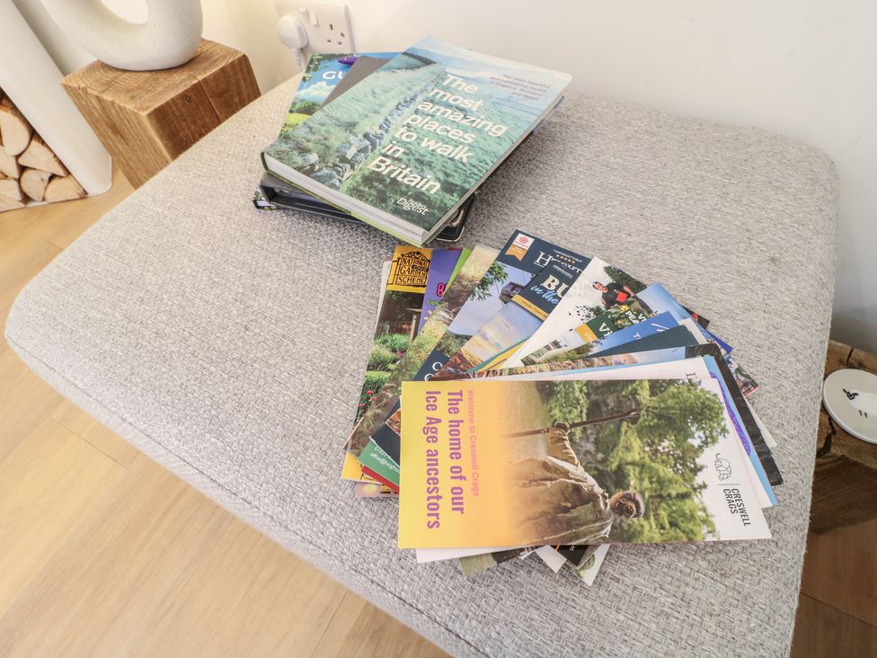 Books and brochures on a table in the sitting room at Little Barn in Grindon