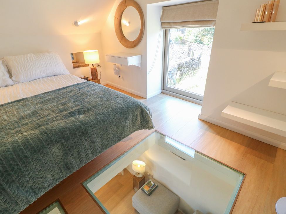 A bedroom with a bed and window at Little Barn in Grindon
