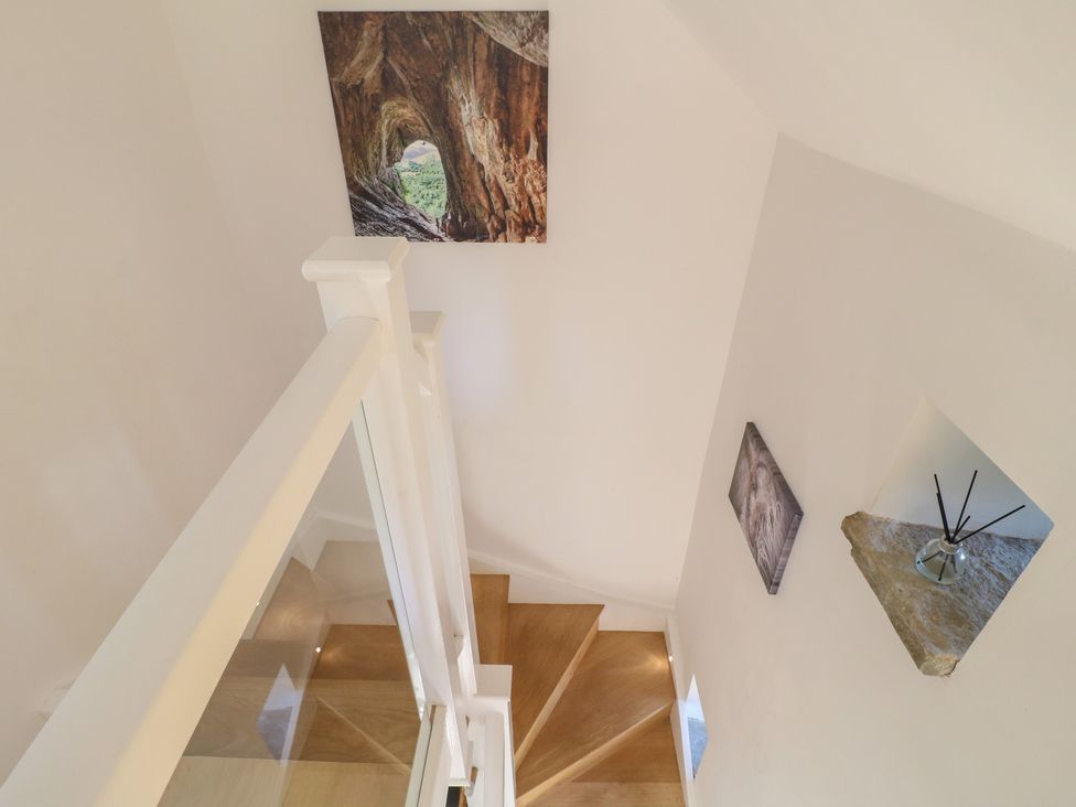 A staircase with decorative pictures at Little Barn in Grindon