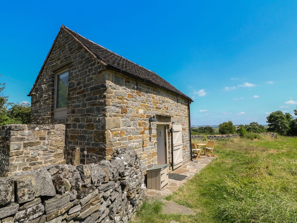 A stone building with a door and windows at Little Barn in Grindon