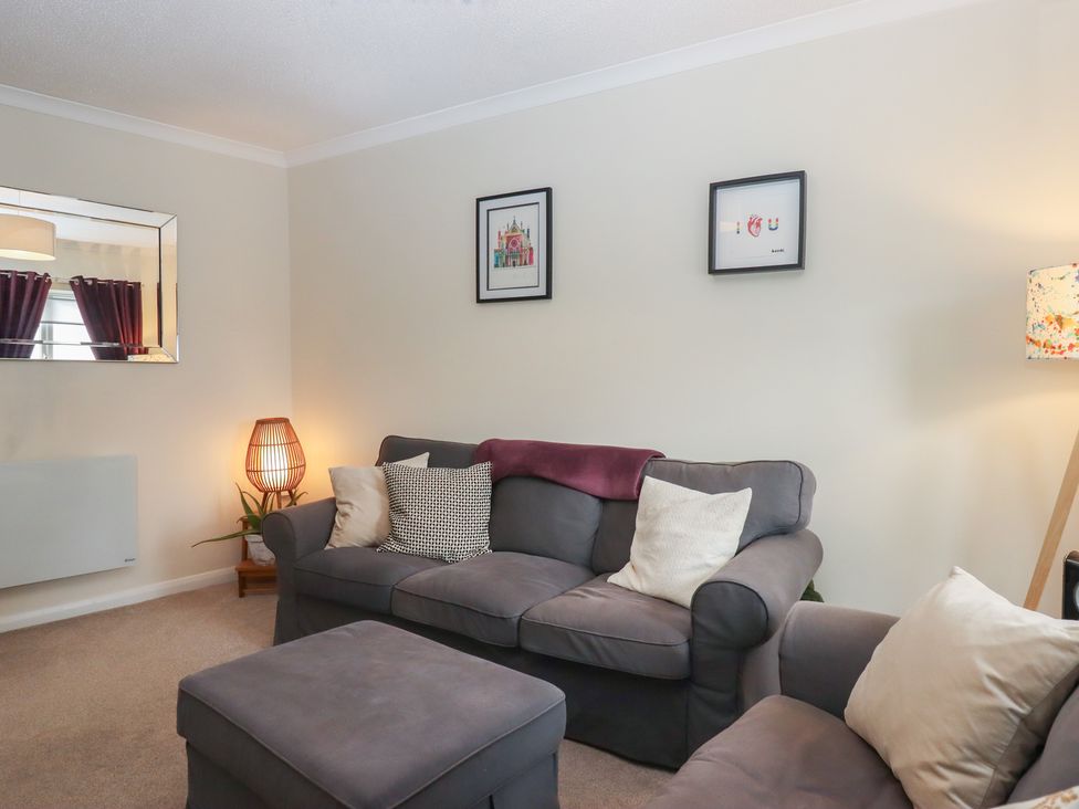 A living room with a sofa and art on the wall at Petitor Mews