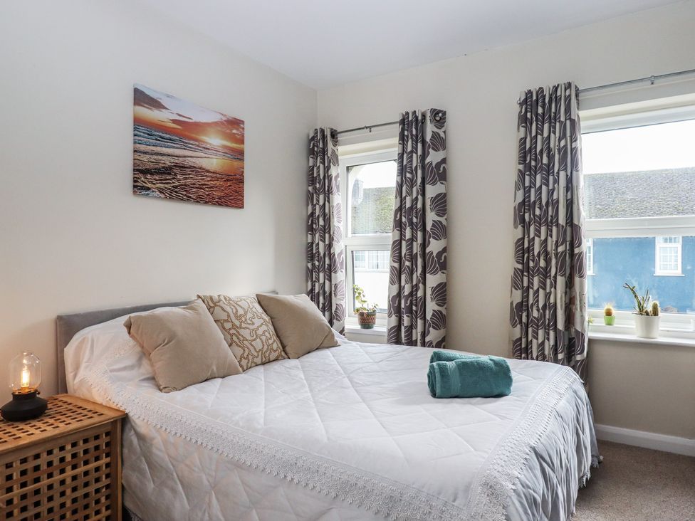 A bedroom with a bed and curtains at Petitor Mews 