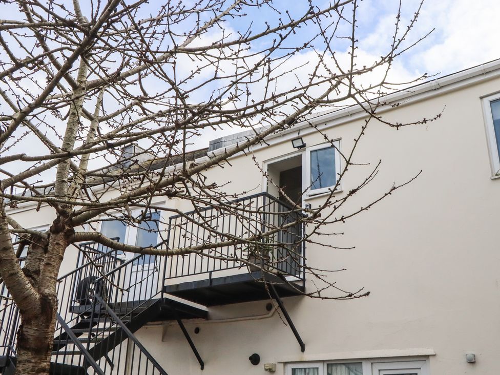 A balcony and stairs of a building with a tree at Petitor Mews