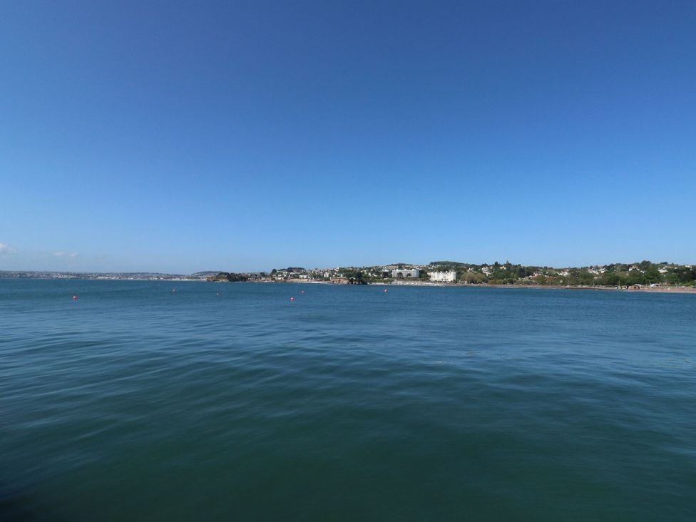 A view of water and land with buildings at Petitor Mews 