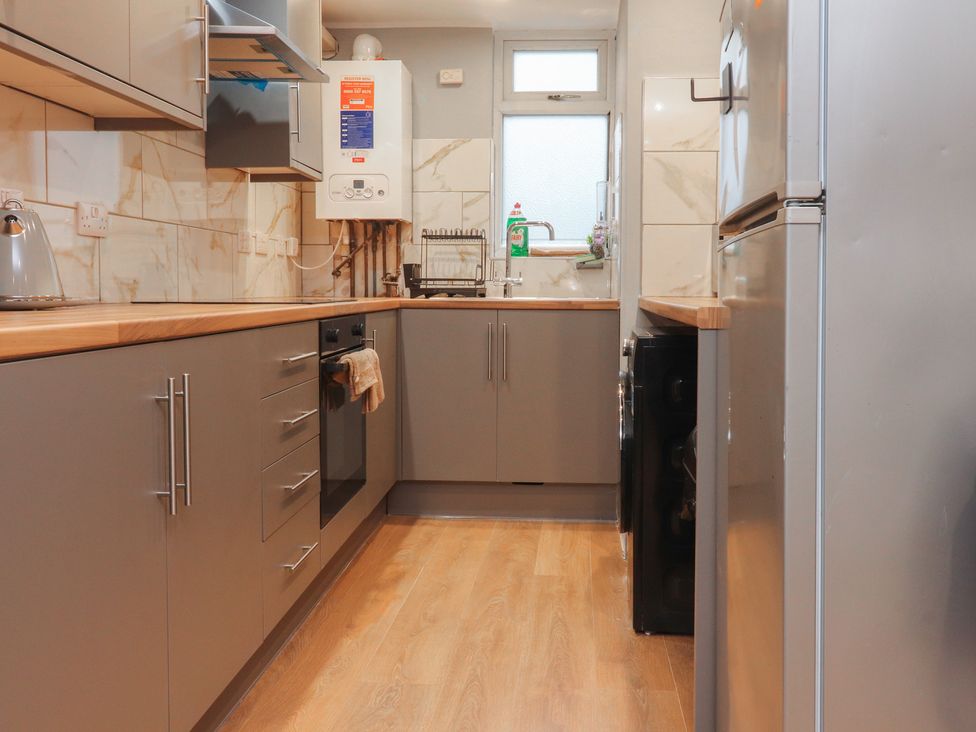 A kitchen with appliances and wooden countertops at 38a Yorkshire Street