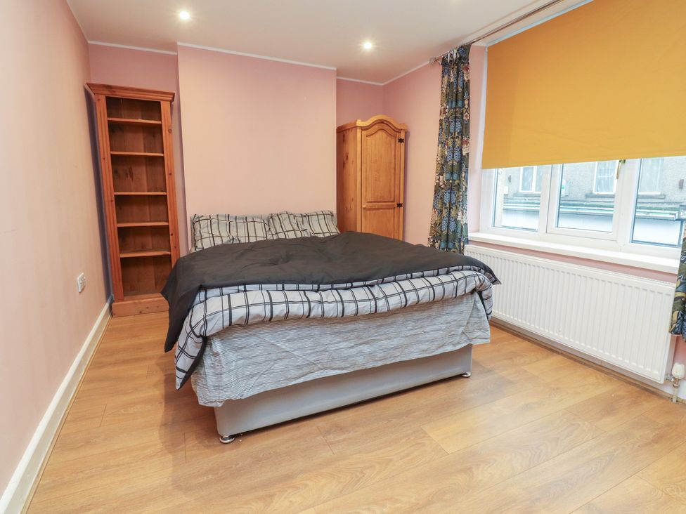 A bedroom with a bed and a bookshelf at 38a Yorkshire Street