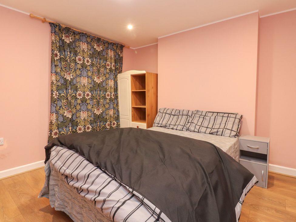 A bedroom with a bed and shelf at 38a Yorkshire Street