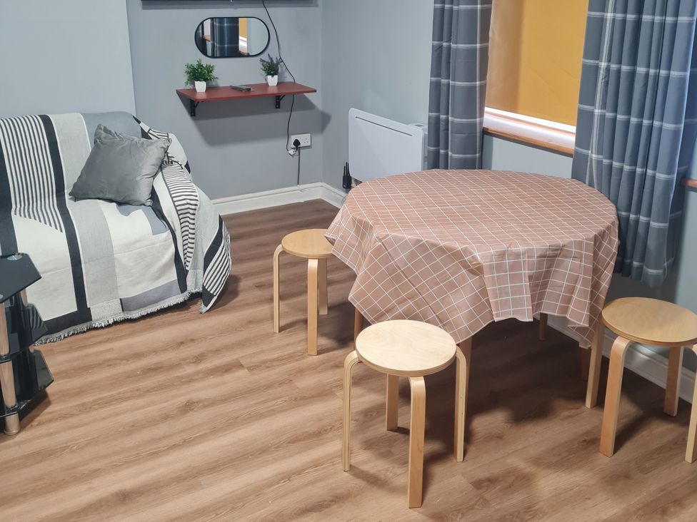 A living room with a sofa and a table at Morecambe Retreat in Morecambe