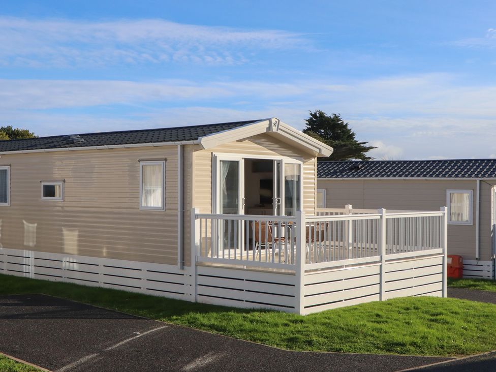 A mobile home with a deck and grass at Caravan C31 at Landscove Holiday Park Brixham