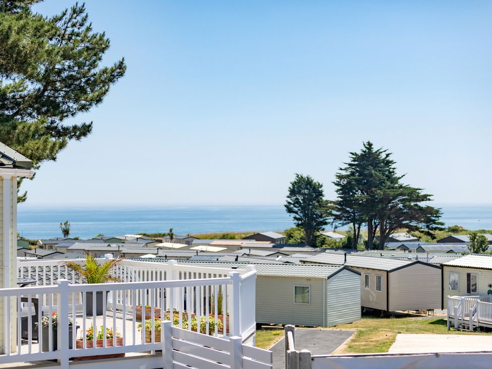 An outdoor view with caravans and ocean at Caravan C31 at Landscove Holiday Park in Brixham