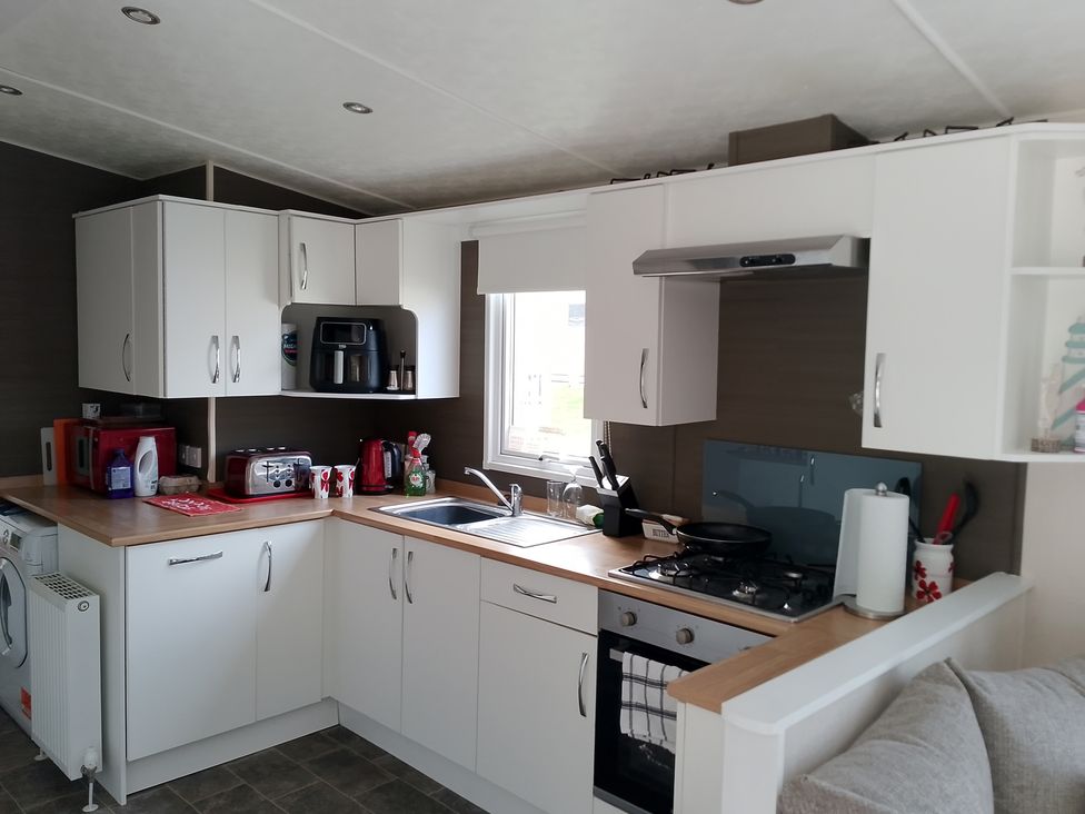 A kitchen with appliances and cabinets at 48 Woodland View in Lymington