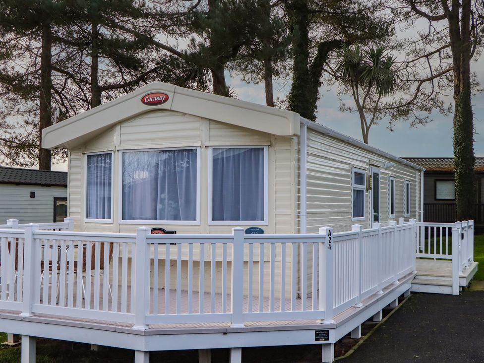 A mobile home with a white railing at Caravan A24 at Landscove Holiday Park Brixham