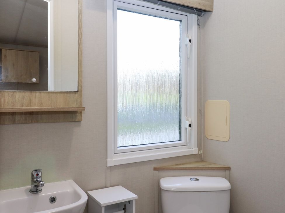 A bathroom with a sink and toilet at Caravan A24 at Landscove Holiday Park Brixham