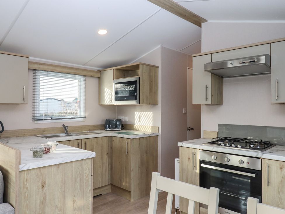 A kitchen with appliances and countertop at Caravan B61 at Landscove Holiday Park Brixham