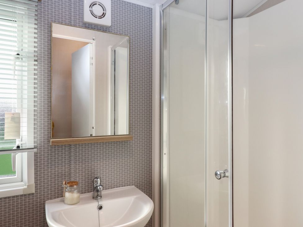 A bathroom with a sink and shower at Caravan B61 at Landscove Holiday Park Brixham