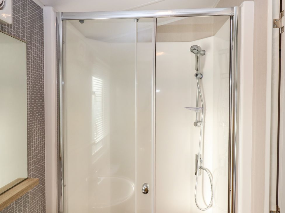 A shower enclosure in a bathroom at Caravan B61 at Landscove Holiday Park Brixham