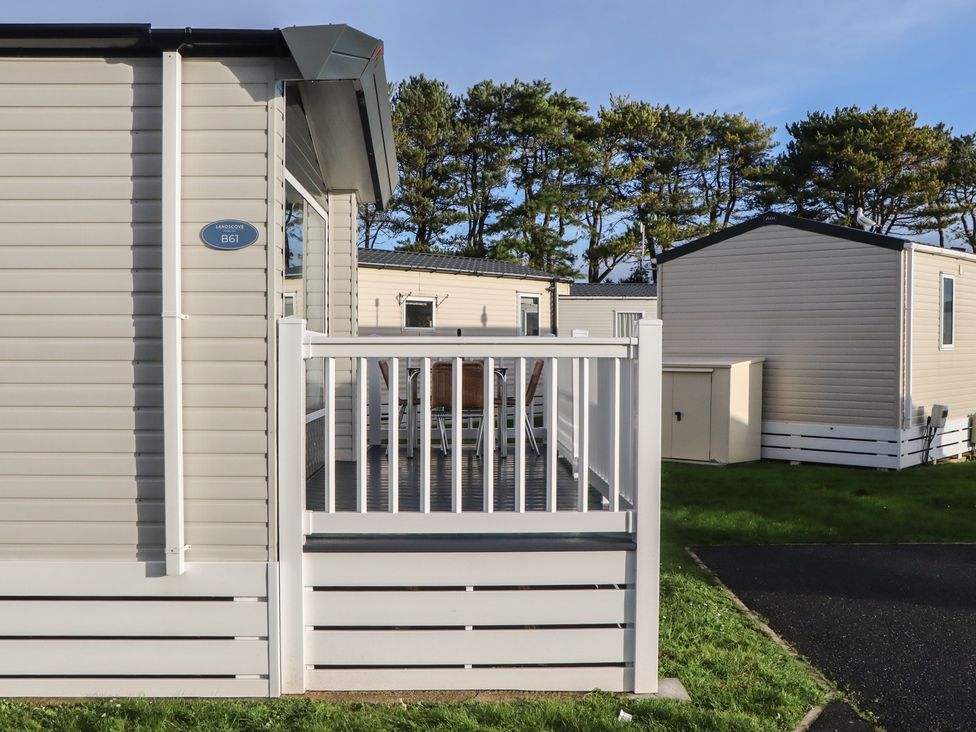A caravan with a deck and a shed at Caravan B61 at Landscove Holiday Park Brixham