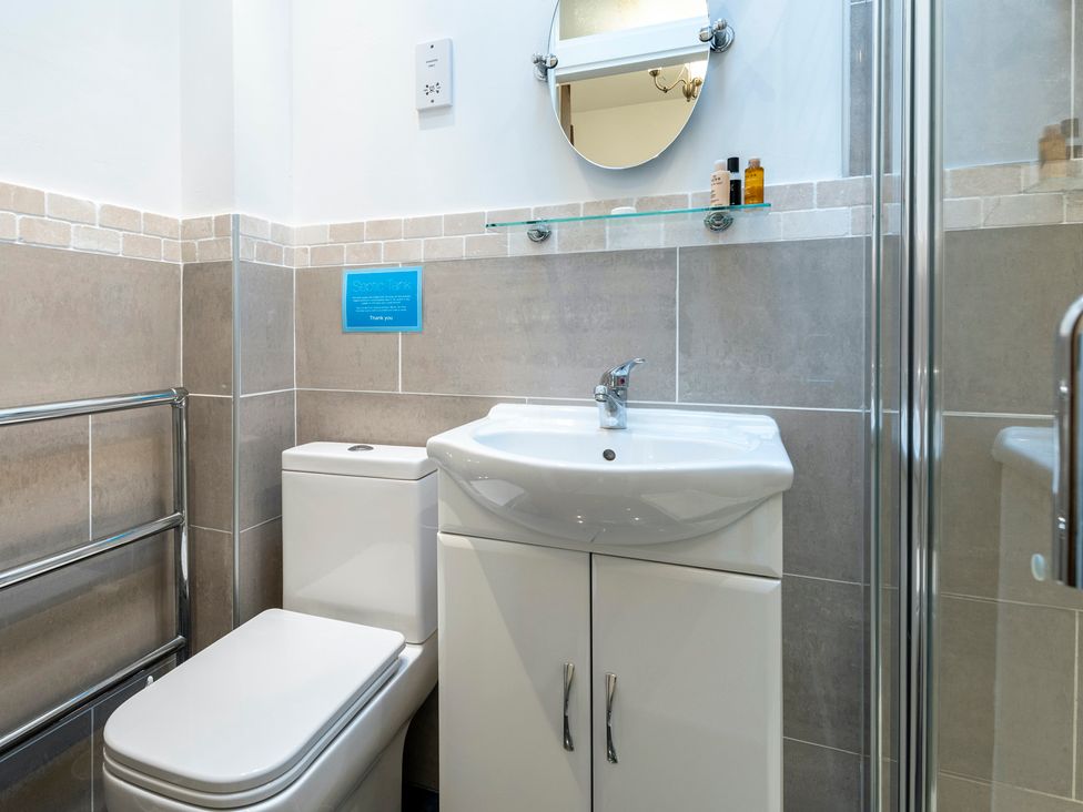 A bathroom with a sink and toilet at Bank House Cottage in Lancaster