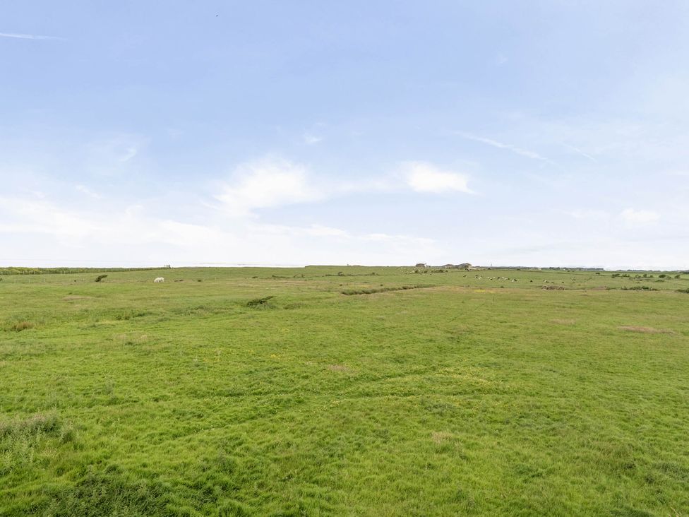 A landscape with grass and hills at Bank House Cottage Glasson Dock
