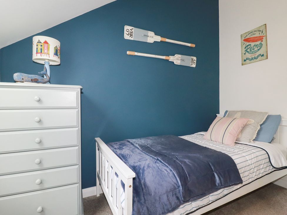 A bedroom with a bed and a chest of drawers at Mill Pond Cottage in Bude