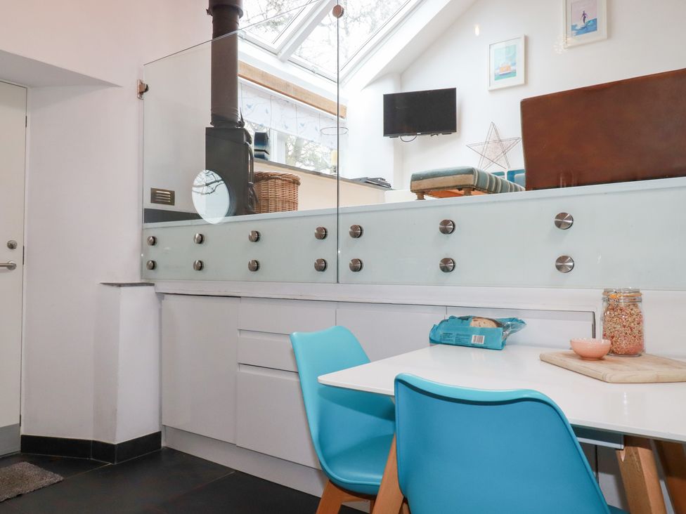 A kitchen with a table and chairs at Meadow View in Bude