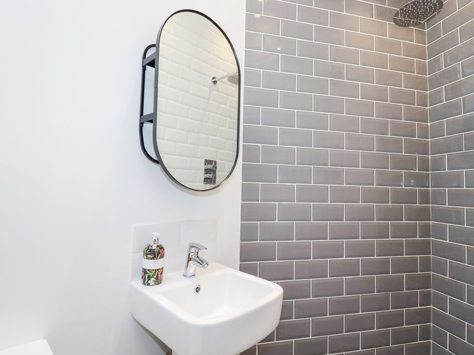 A bathroom with a sink and shower at Meadow View in Bude