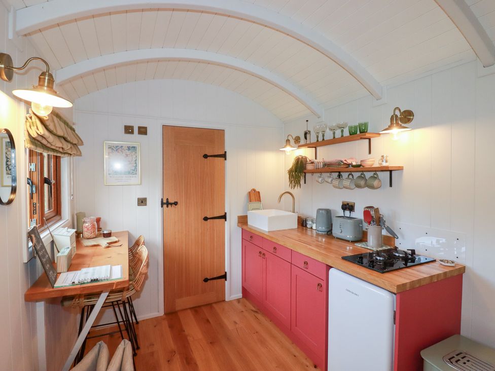 A kitchen with a wooden counter and appliances at Bryar in Bude
