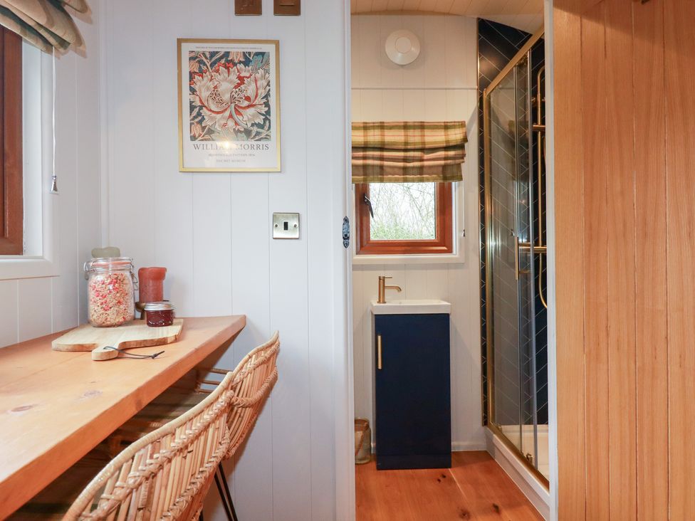 A kitchen area with a table and sink at Bryar in Bude