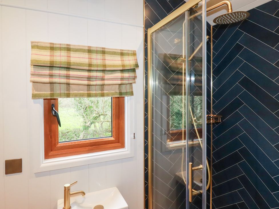 A bathroom with a shower and window at Bryar in Bude