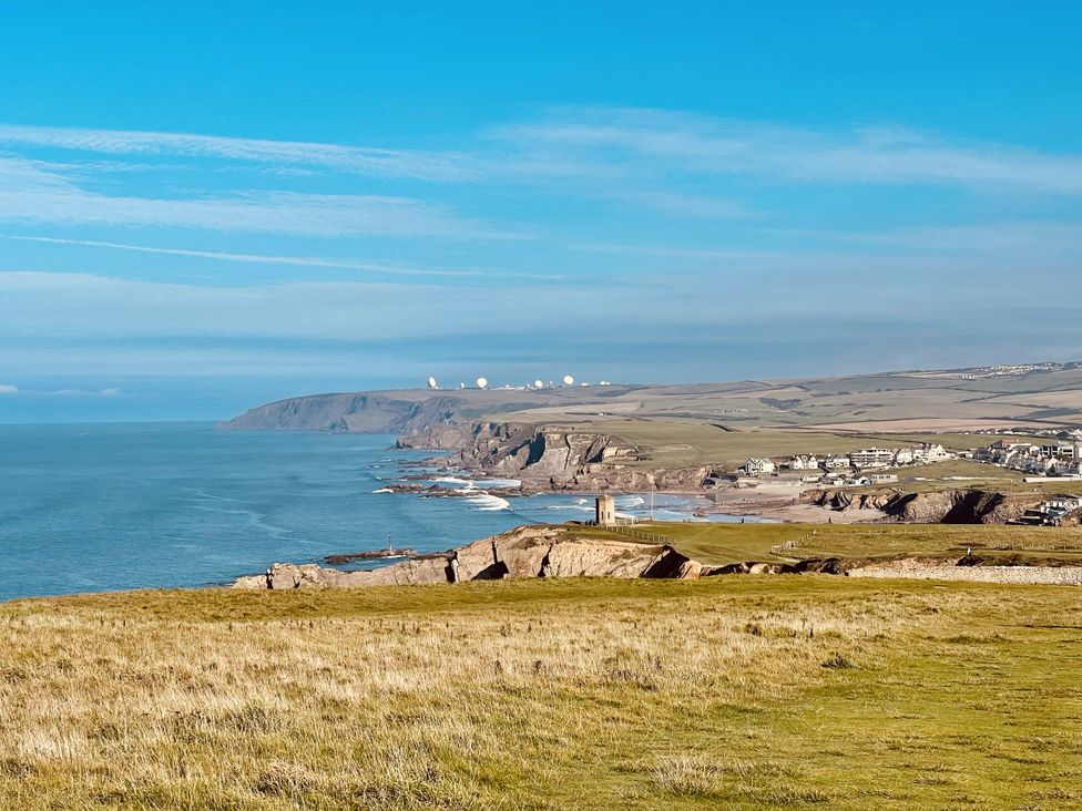 A scenic view of cliffs and ocean at Bryar in Widemouth Bay