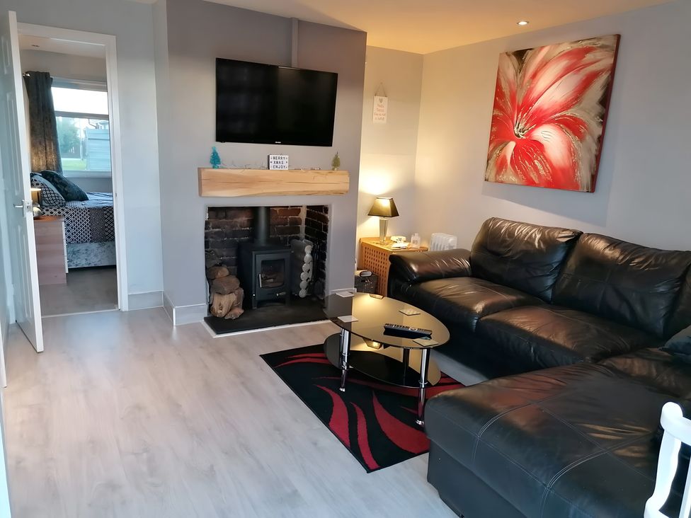 A living room with a television and sofa at Sea View Retreat in Bridlington