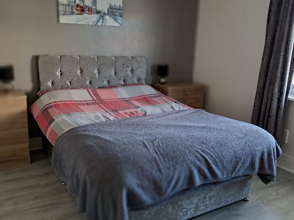 A bedroom with a bed and bedside tables at Sea View Retreat in Bridlington